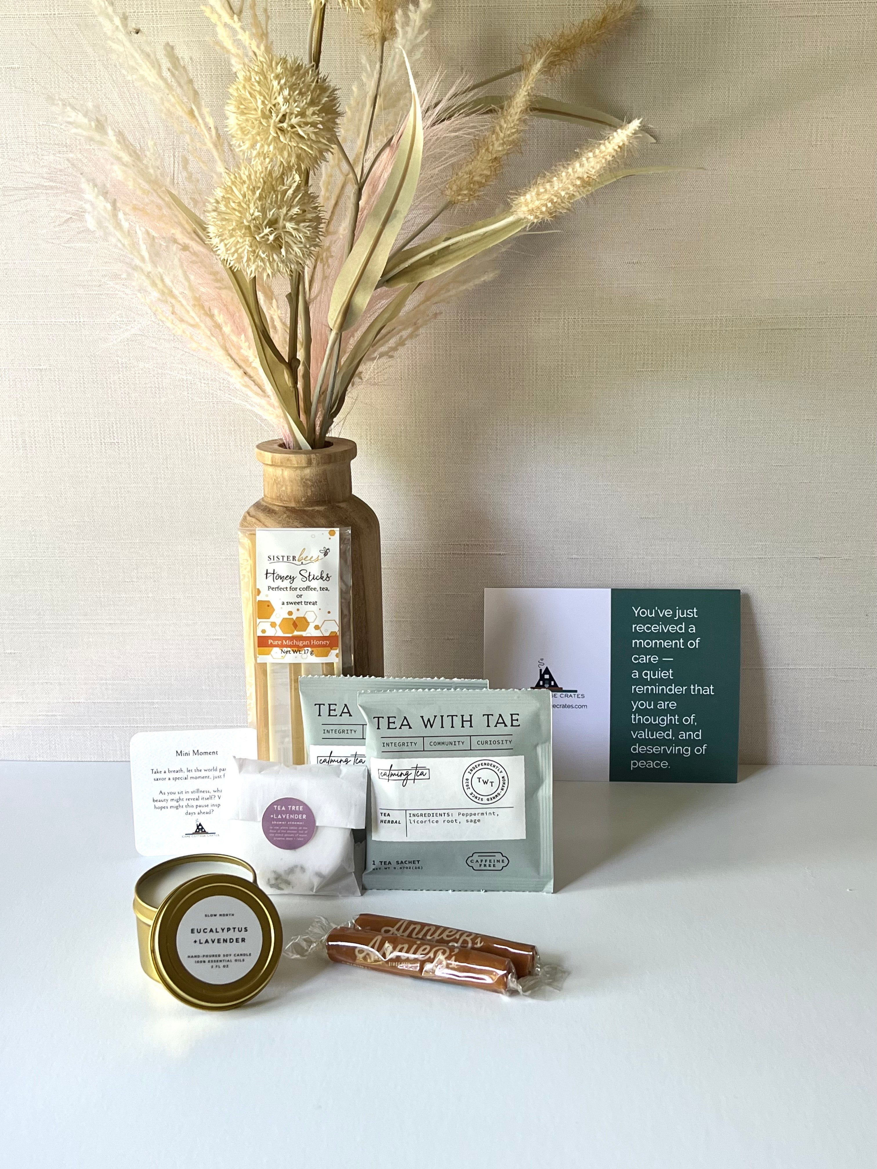 Shower Steamer, Calming Tea Packes, Honey Sticks, Caramels, and mini candle make for a thoughtful gift. Includes a thoughtful prompt and a custom playlist for a moment of peace.
