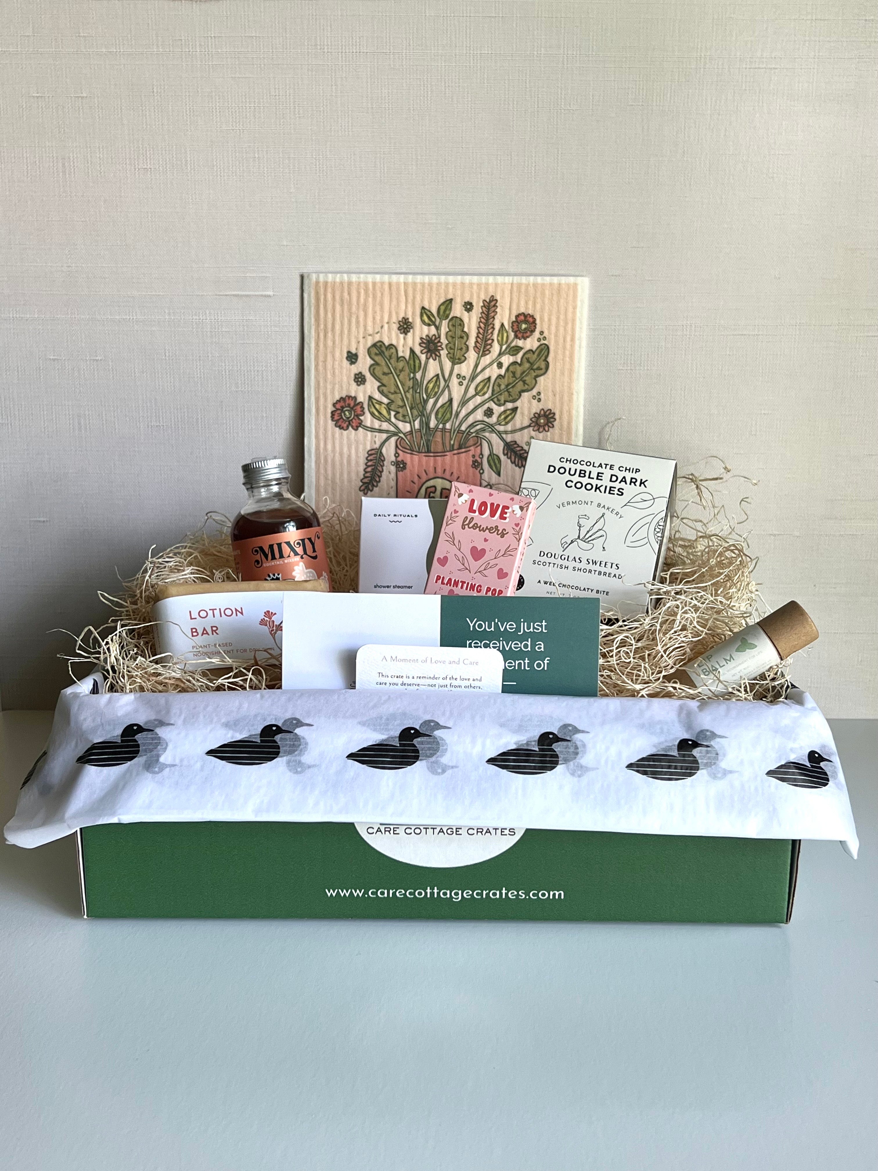 Seasonal gift including strawberry cocktail/mocktail mixer, shower steamer, reuseable paper towel, double chocolate chip cookies, herb seed pop, chapstick, lotion bar. Includes a thoughtful prompt and curated playlist to encourage a moment of warmth and care.