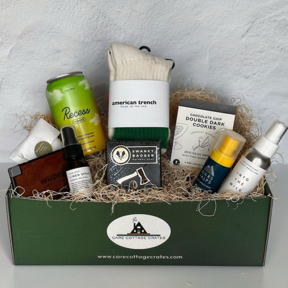 Walk in the Woods Crate with nine outdoors-inspired self-care products arranged in a gift box, including socks, drink, soap, and spray.