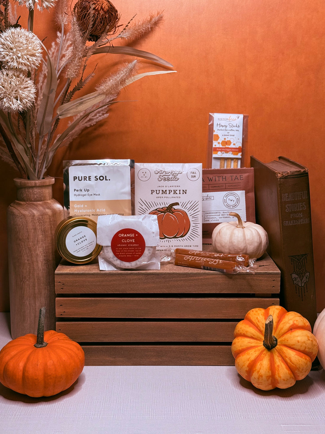 Products included in the Autumnal Mini Moment such as a Pure Sol Eye Mask, Slow North Mini Candle, and Tea with Tae tea sachets.